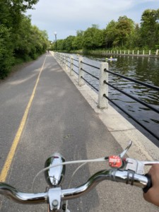 POV of Way cycling on a mutli-use path right next to a river. 