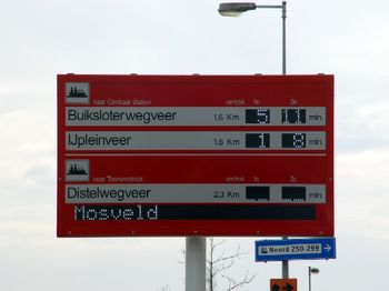 Sign with the next departures of the ferry from Amsterdam